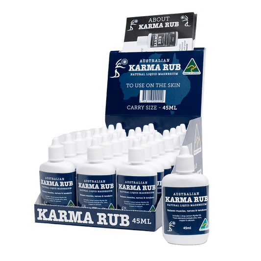 Box of 24 Karma Rub Liquid Magnesium 45ml bottles, featuring colorful packaging and the product label visible.